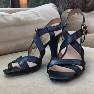 Joan and David black strapped leather heels.